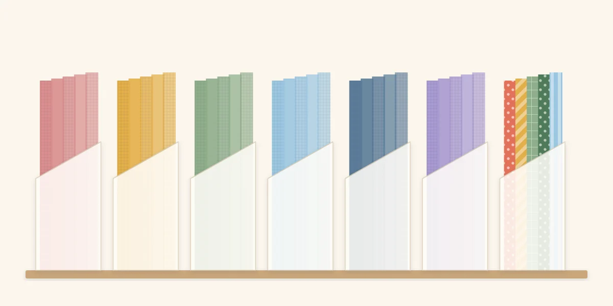 Cardstock stored upright in holders sorted by color family, with patterned paper kept separately