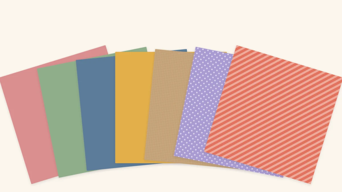 A fan of solid cardstock sheets in five colors with dotted and striped patterned paper on top